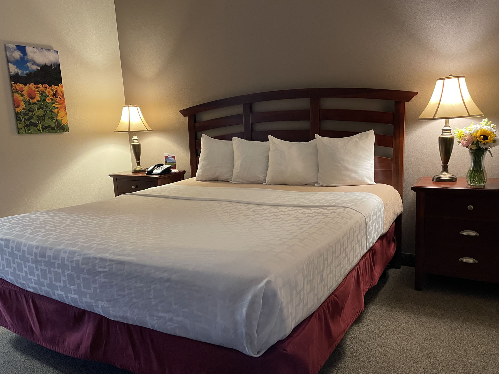 a hotel room with a bed and two lamps