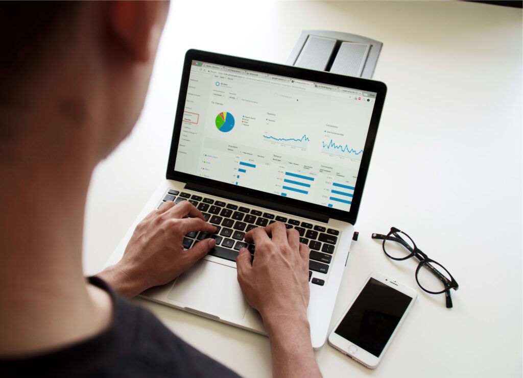 Man views social media metrics on laptop