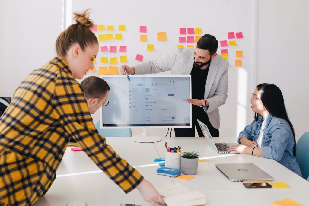 Group of four business professionals holding an interactive meeting.
