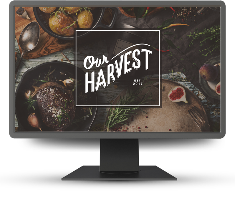 Monitor displaying home page of Our Harvest
