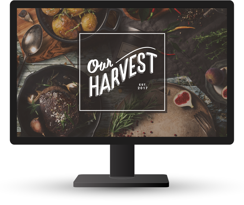 Monitor displaying home page of Our Harvest