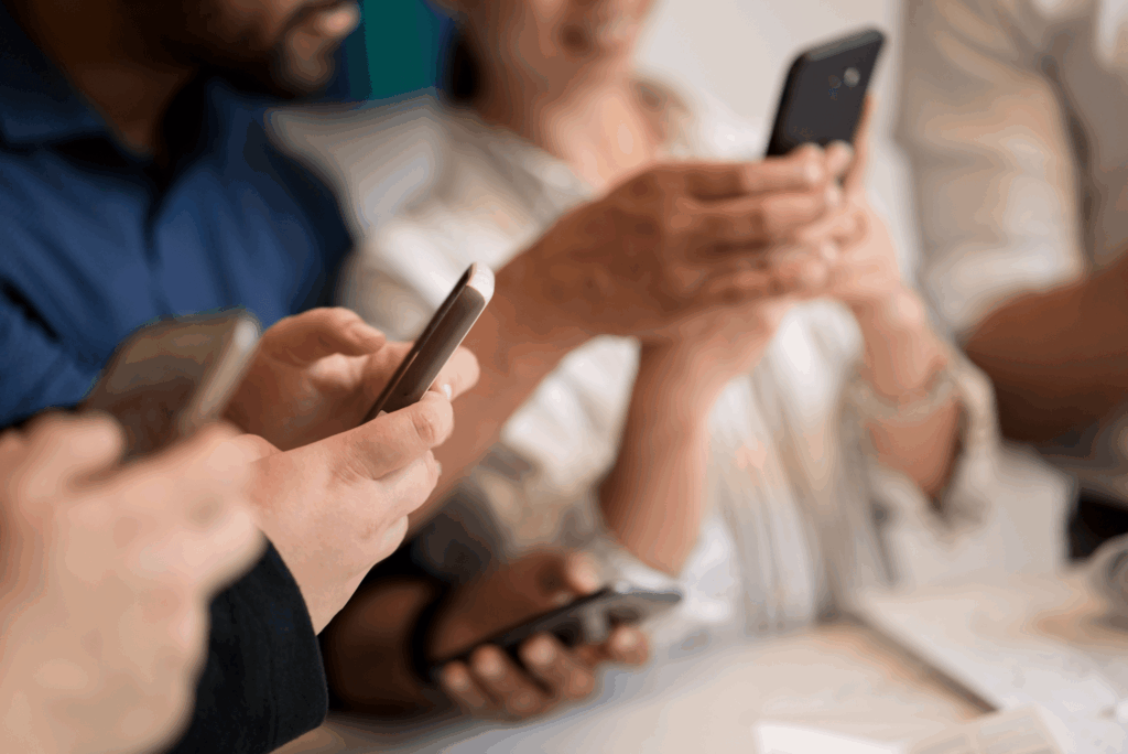 Four people looking at their phones