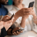 Four people looking at their phones