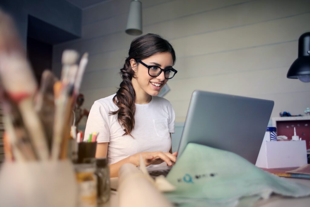 Brunette woman with glasses using laptop