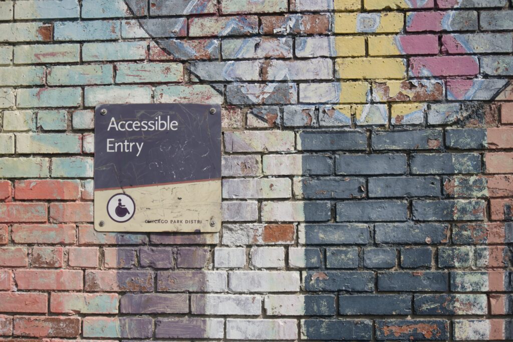 Brick wall with accessible entry sign