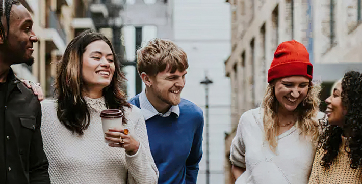 Young people standing in laughing in a city environment for Youth Empowered Society D3 Case Study