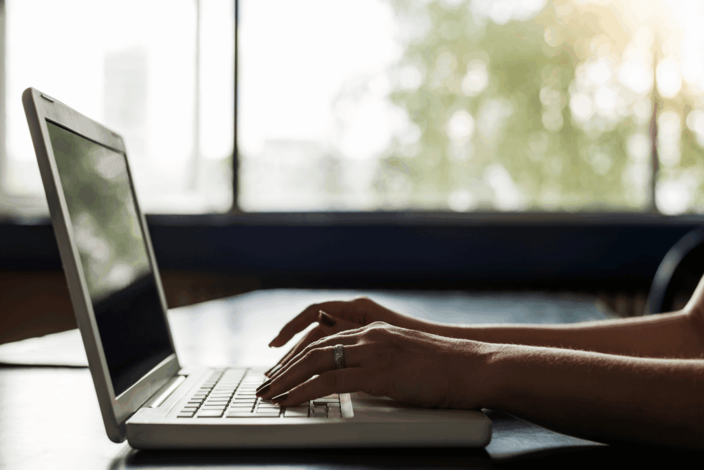 person sitting at a laptop typing