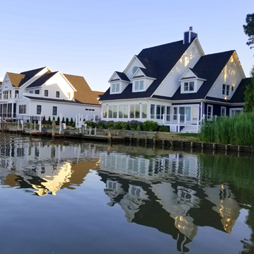 a row of houses sitting next to a body of water