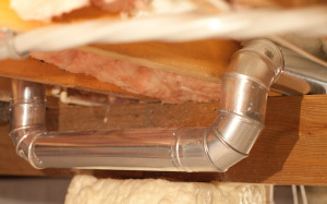 a close up of a metal pipe on a piece of wood