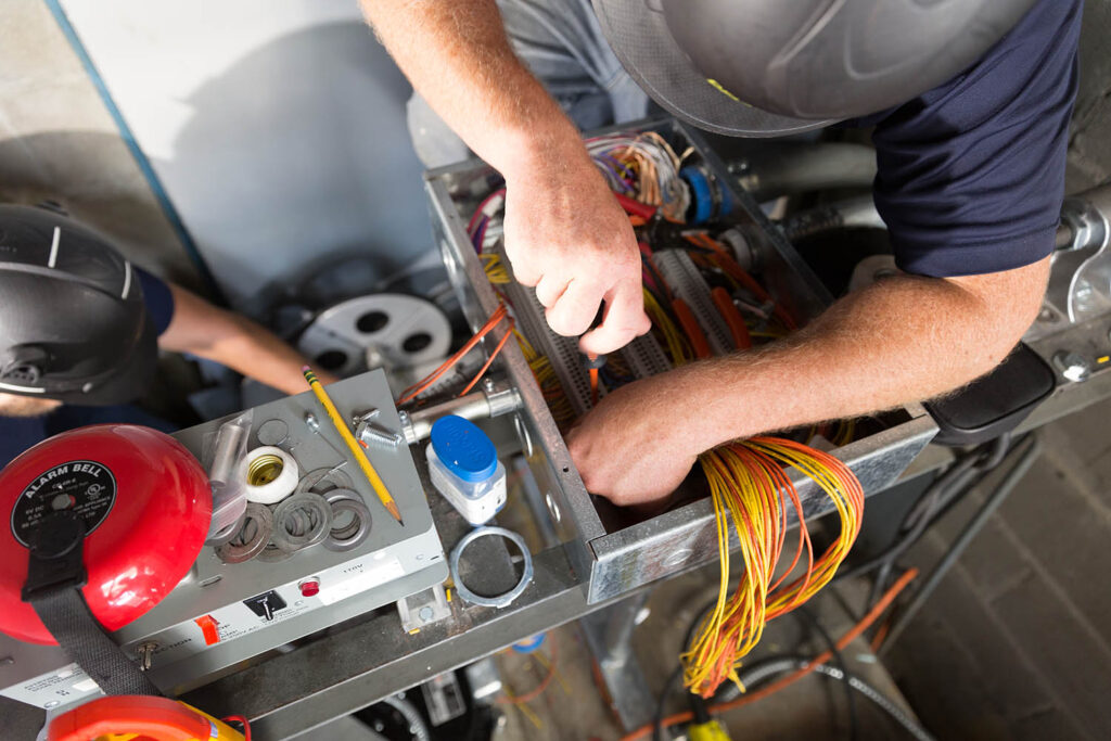 a man working on a machine in a room