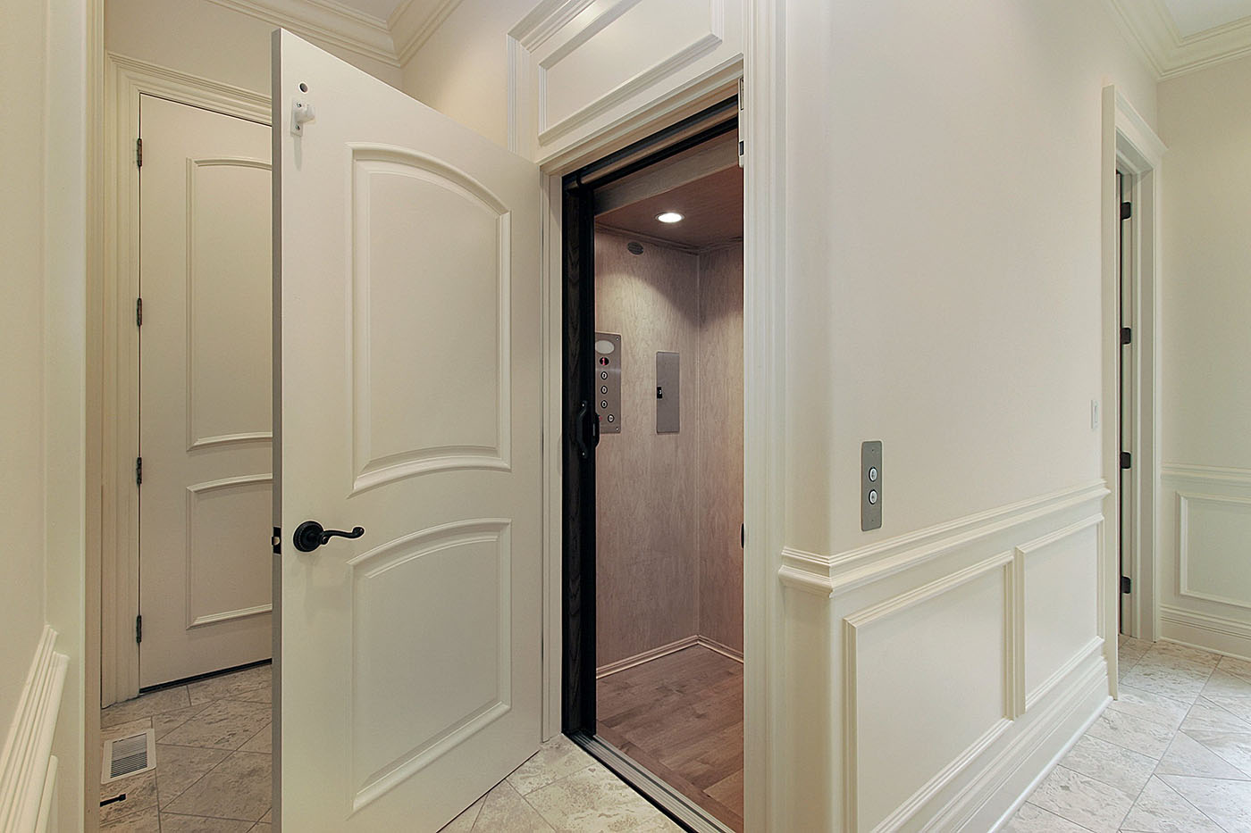 a hallway with white walls and a door