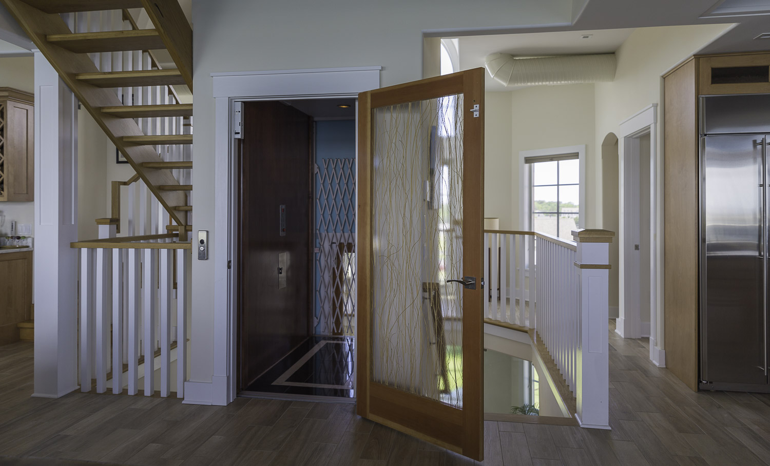 an open door leading to a kitchen and living room