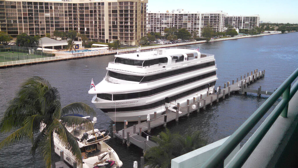 a large white boat docked at a pier