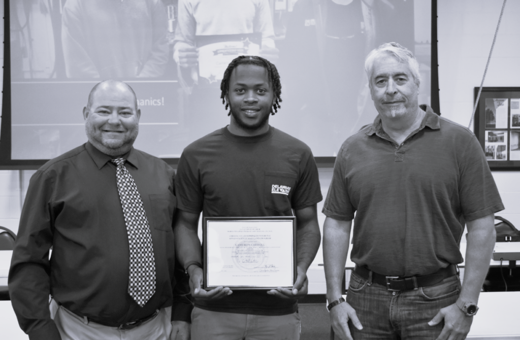 a group of three men standing next to each other