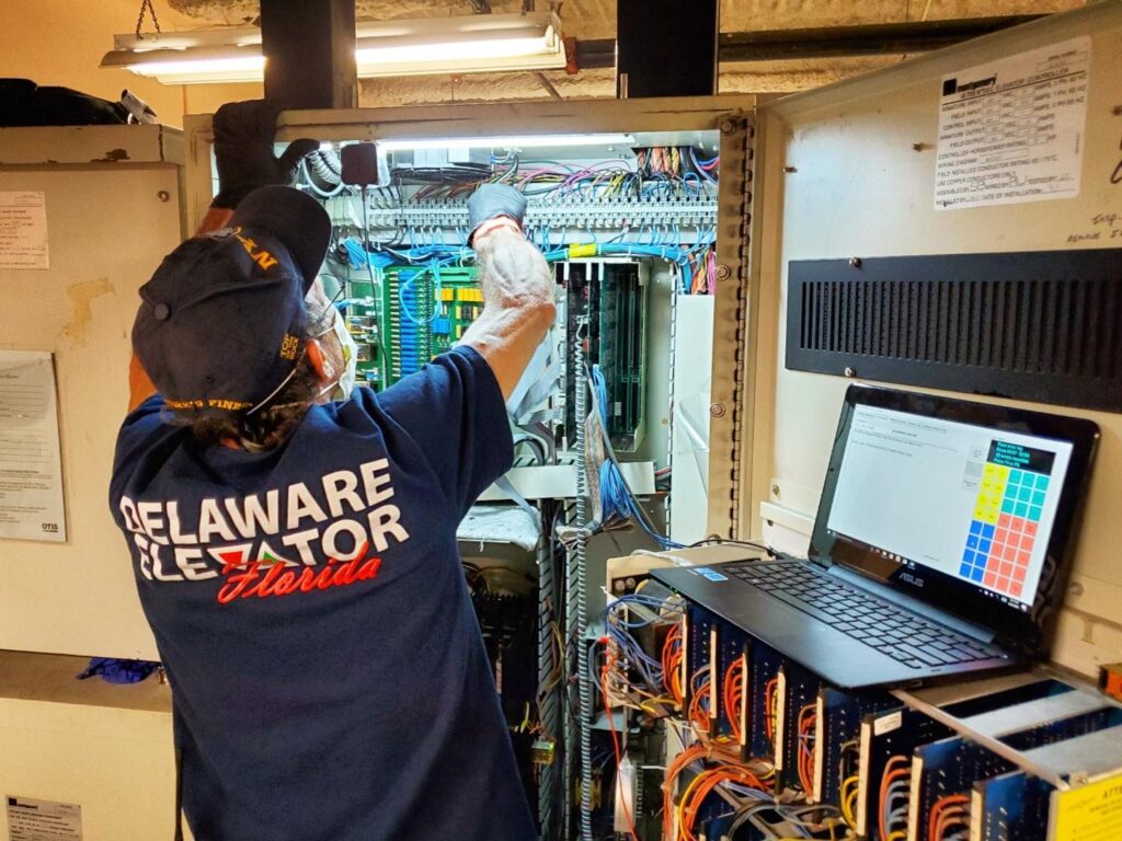 a man working on a computer inside of a building
