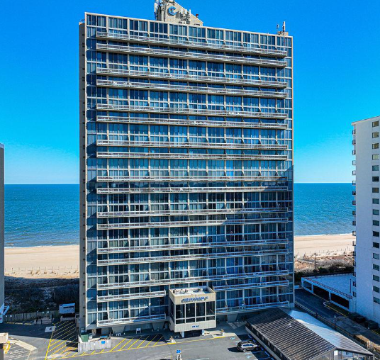 a tall building next to the beach