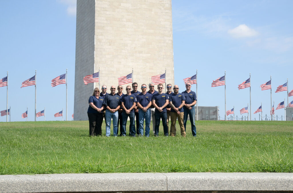 a group of men standing in front of a monument