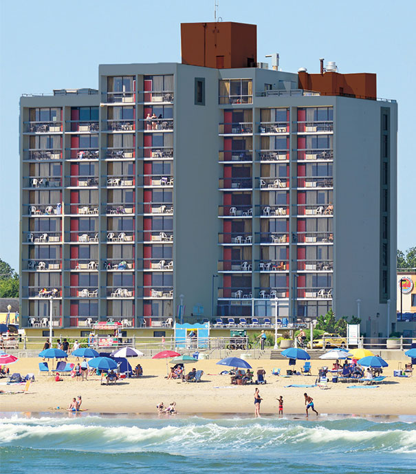 a beach with a hotel in the background