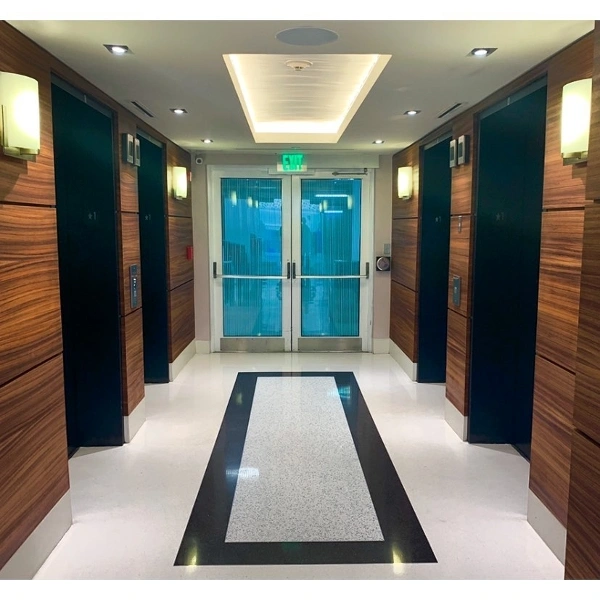 a long hallway with a black and white floor
