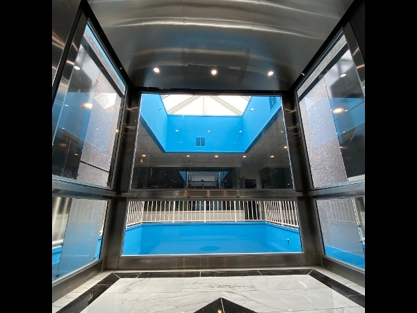 an empty building with a blue pool inside of it