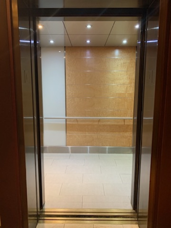 a glass door leading to a room with a tiled floor