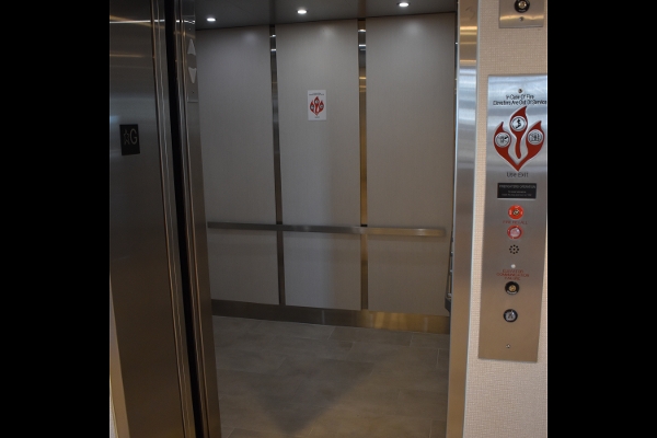 an elevator with a red and white sign on it