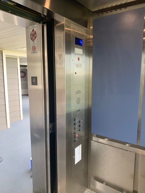 a stainless steel elevator in a building
