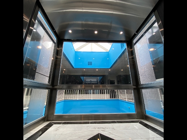 the inside of a building with a blue pool