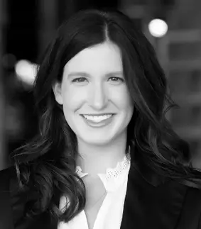 a black and white photo of a woman smiling