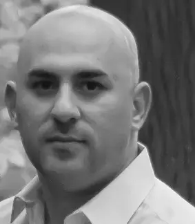 a black and white photo of a bald man