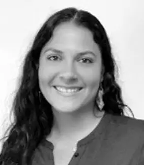 a black and white photo of a smiling woman