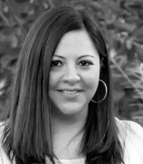 a black and white photo of a woman smiling