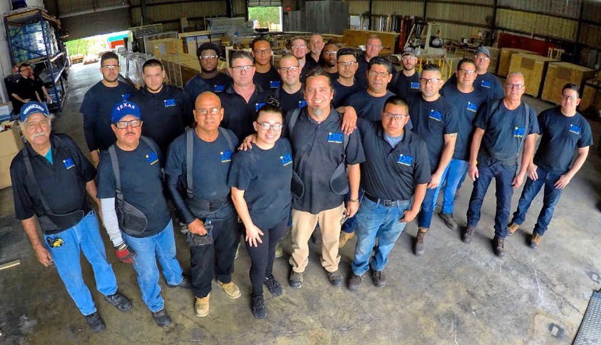 a group of men standing next to each other in a warehouse