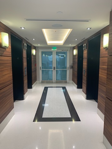 a long hallway with a black and white floor