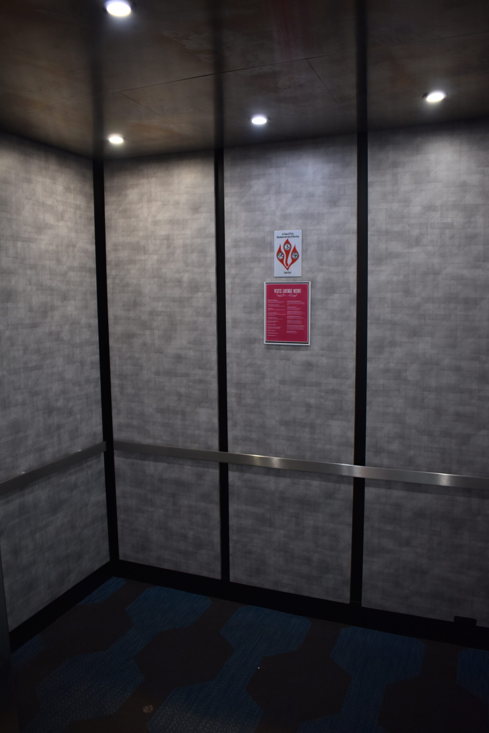 a dimly lit room with a sign on the wall