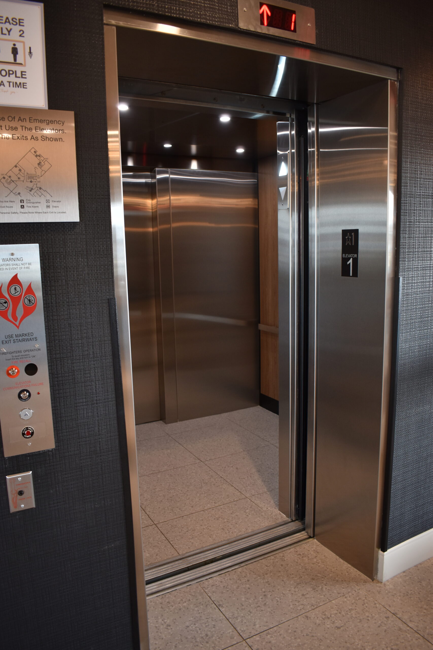 a stainless steel elevator in a building