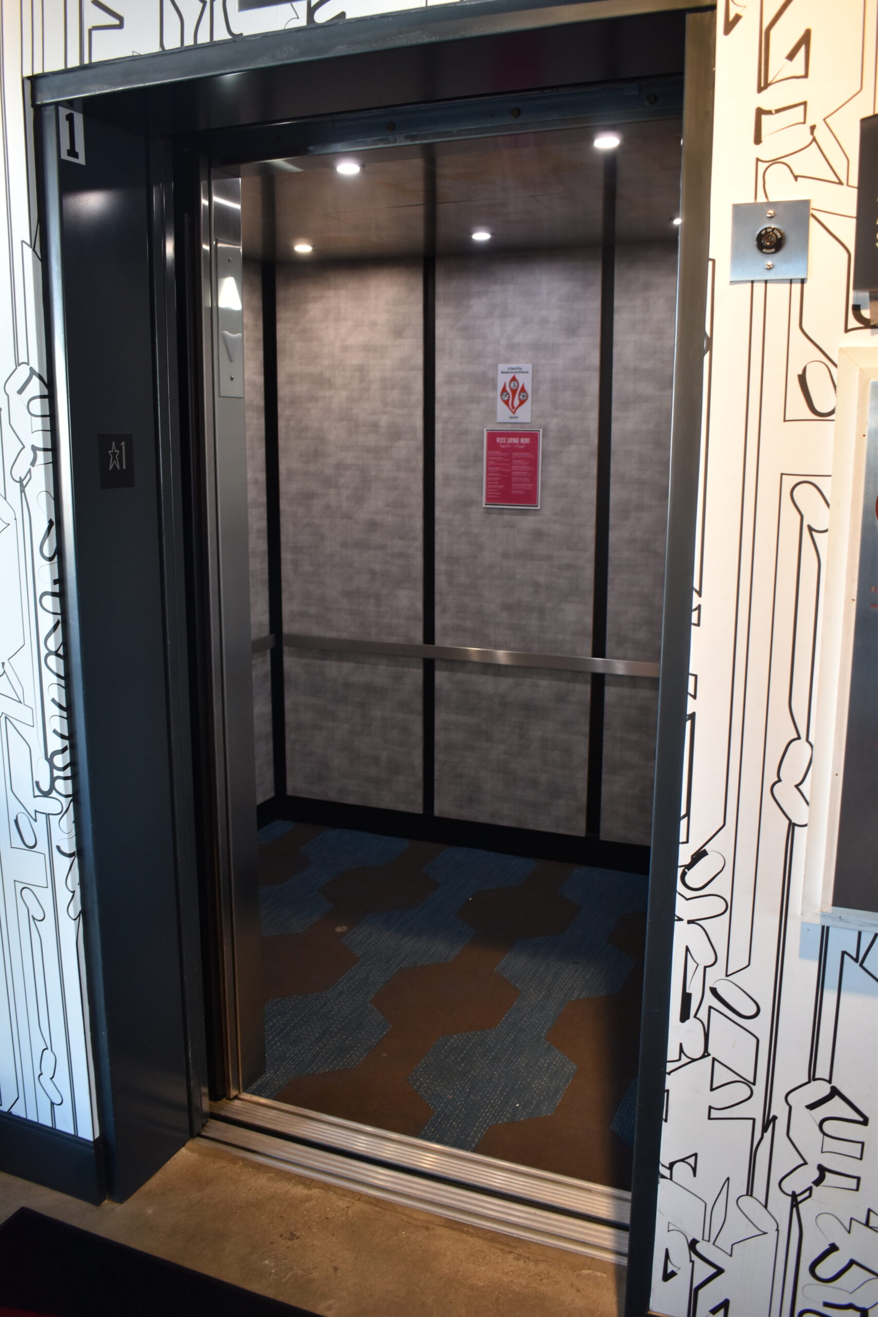 an empty elevator with graffiti on the walls