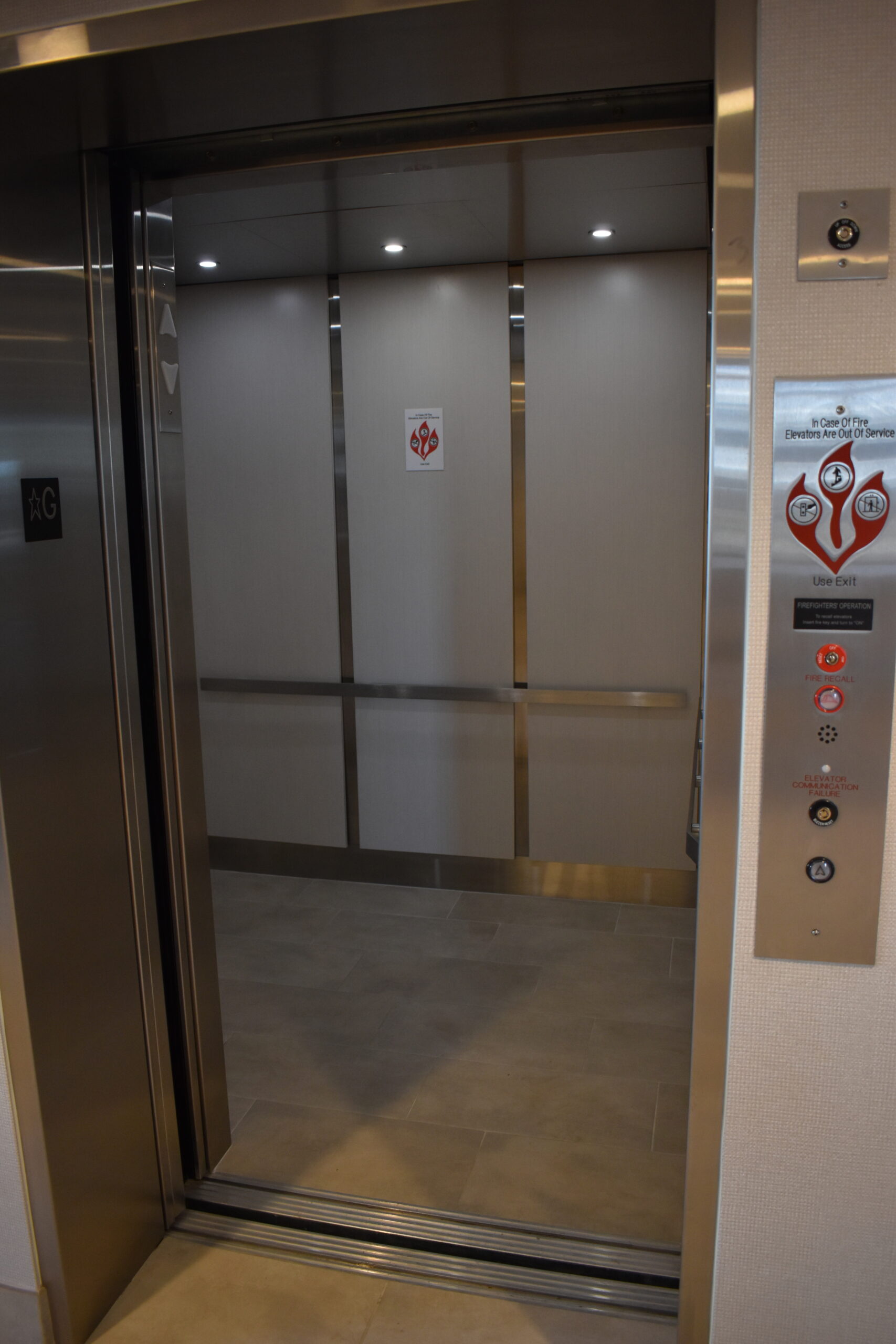 a stainless steel elevator in a building