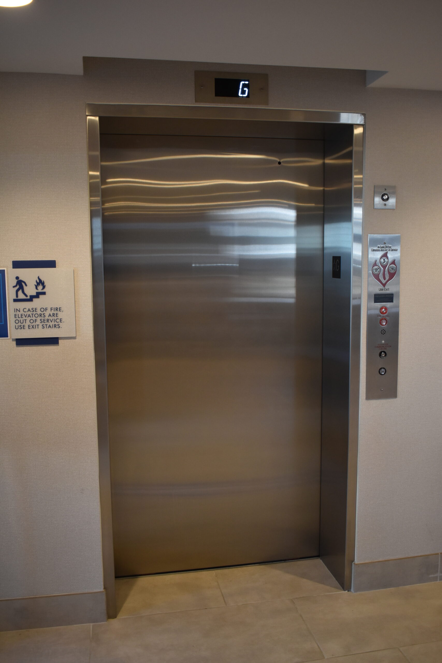 a large stainless steel elevator in a building