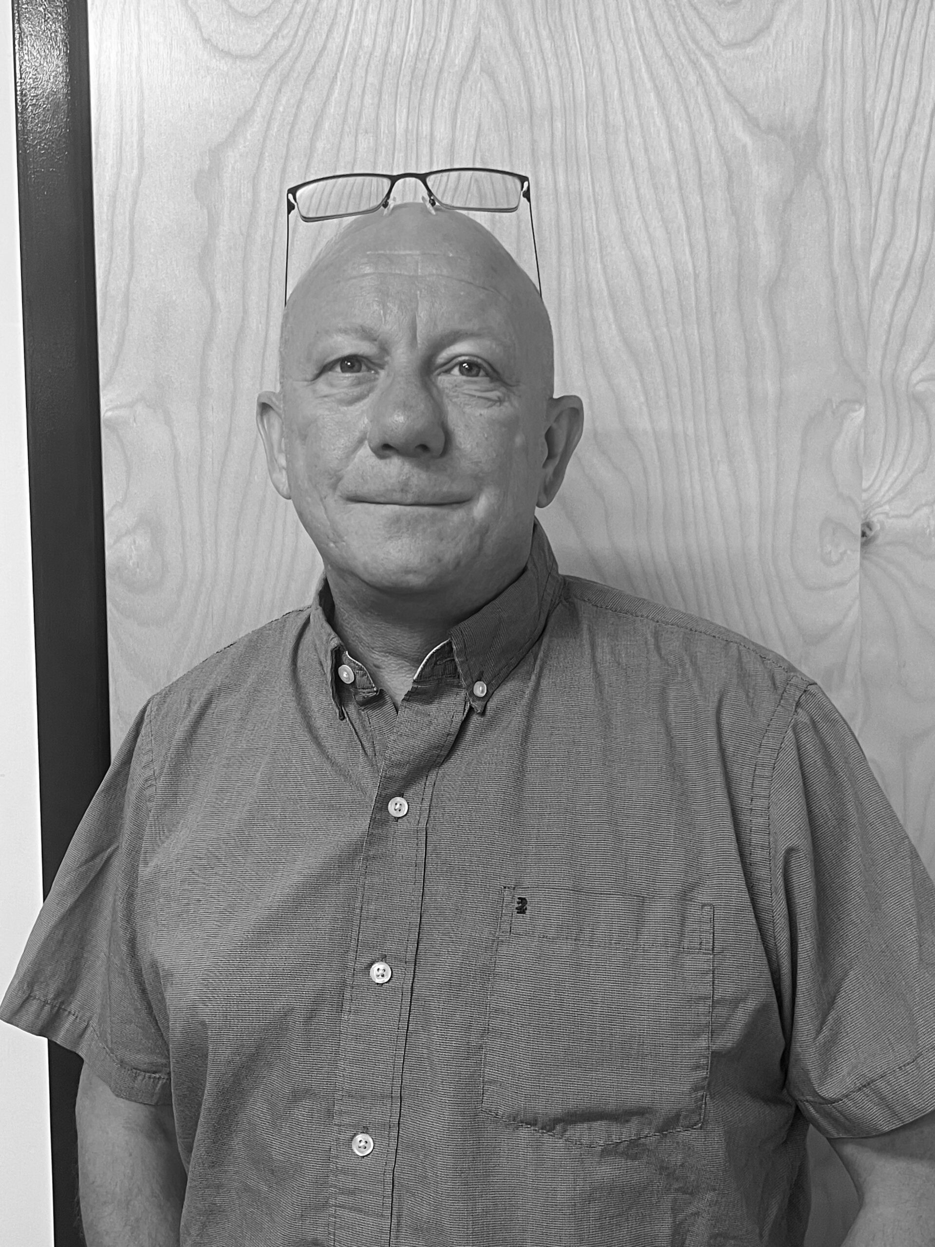a black and white photo of a man with a bald head