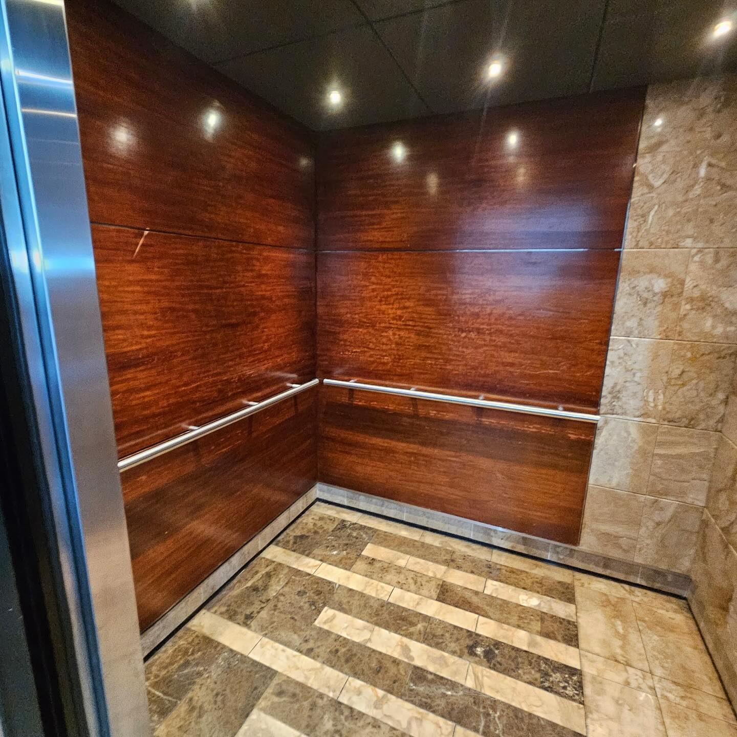 a bathroom with a tiled floor and wooden walls