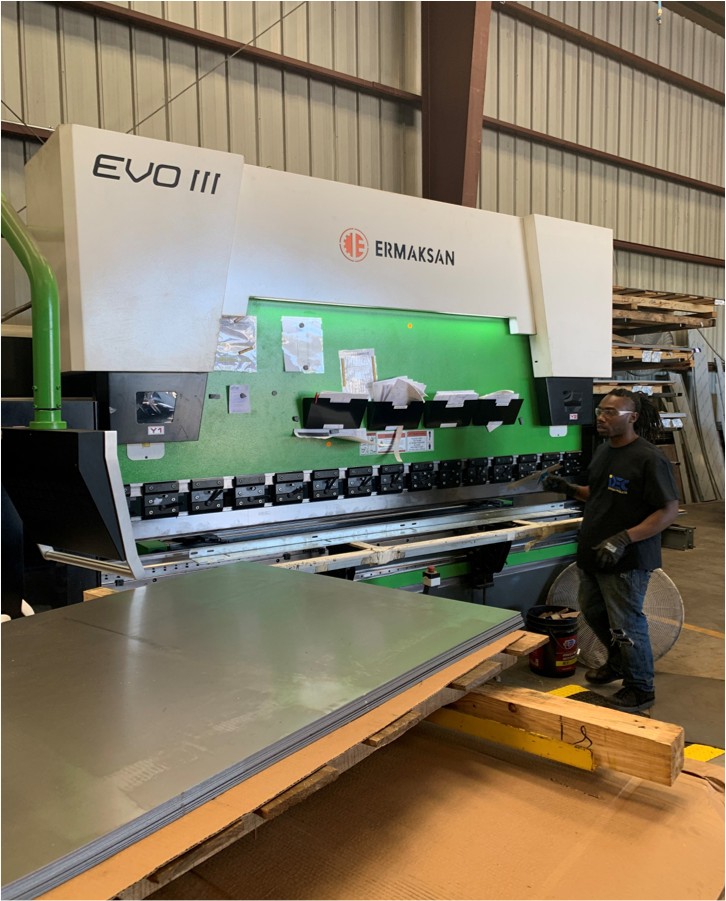 a man standing in front of a machine