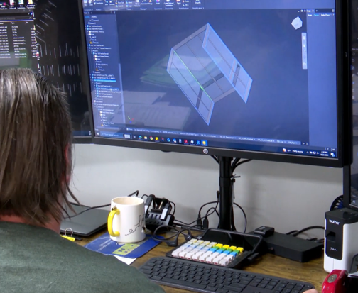 a person sitting at a desk in front of a computer