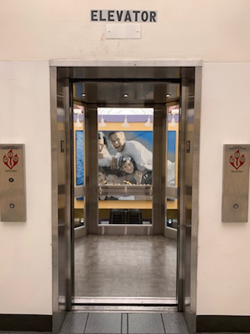 an elevator with a picture of a man on the wall