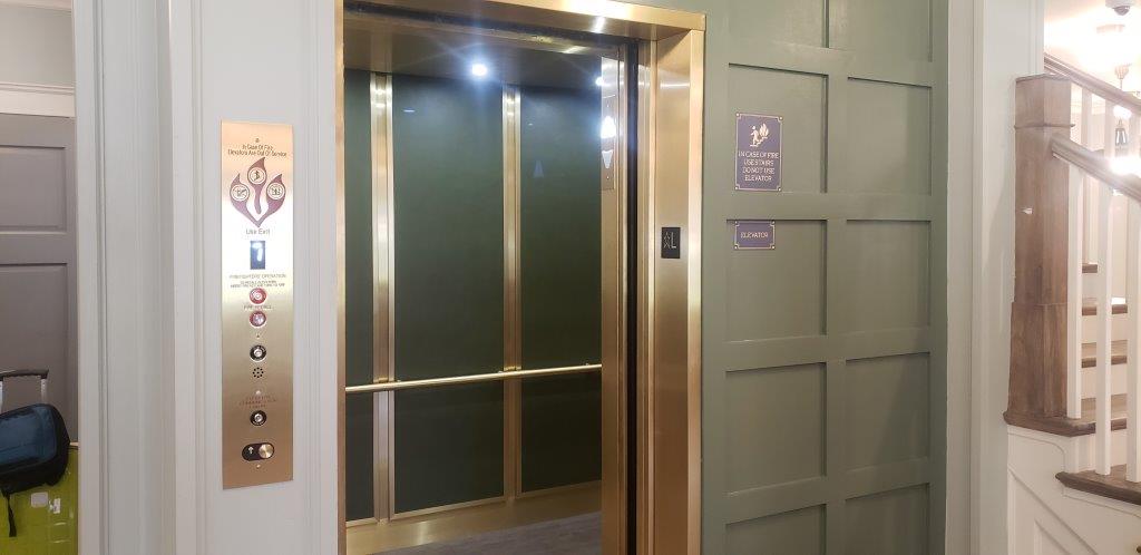 a gold door is open in a hallway