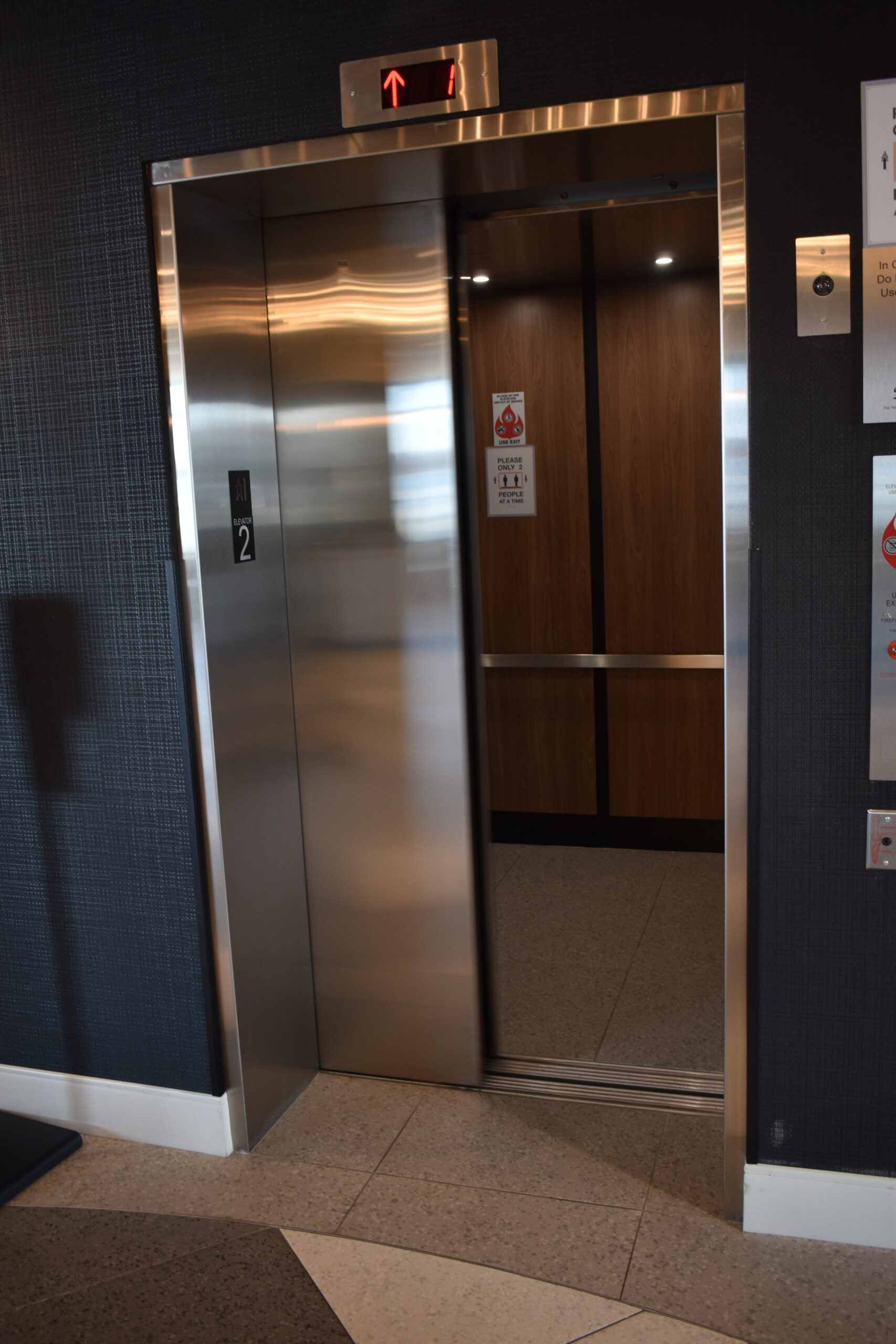 an elevator in a building with signs on the walls