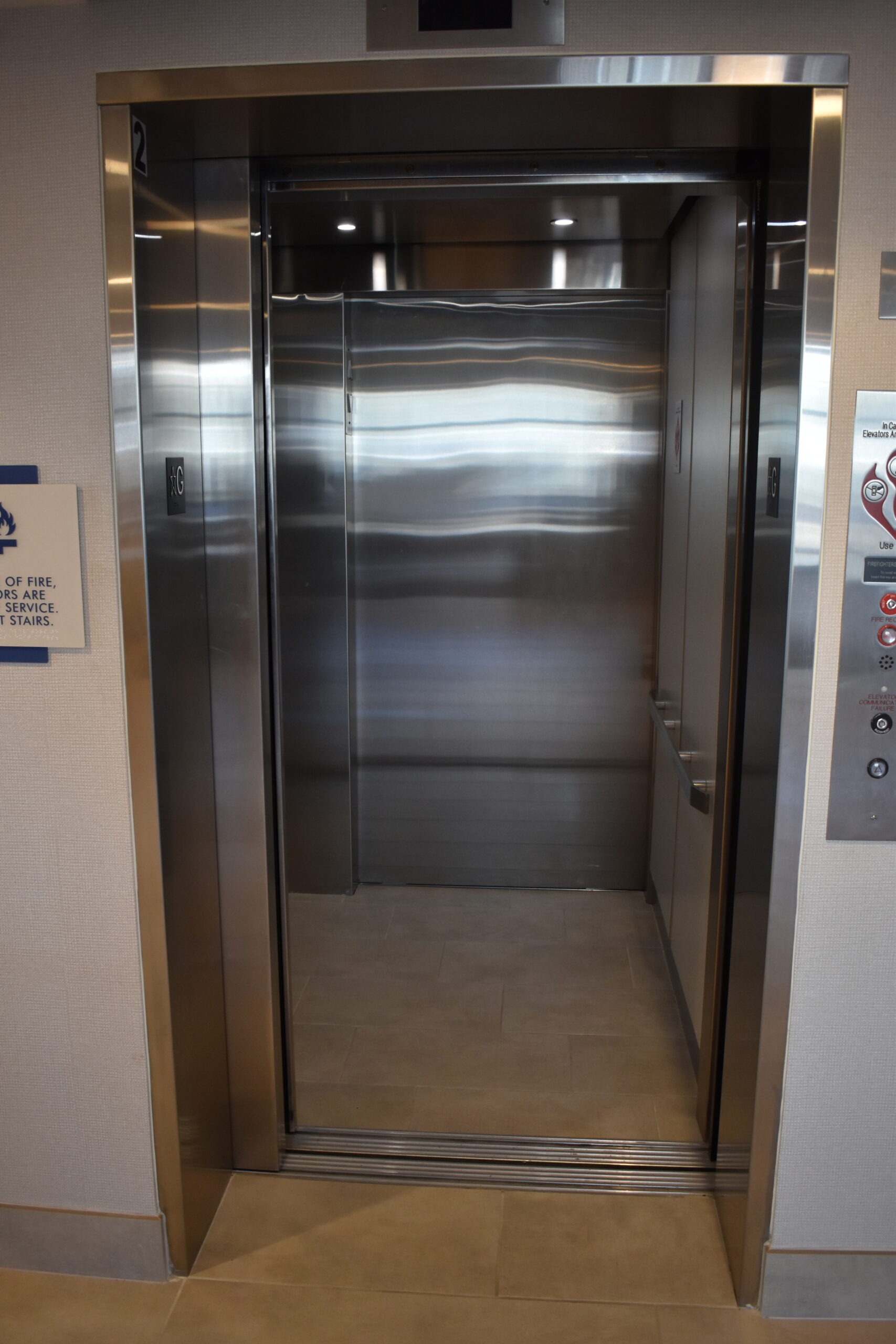 a stainless steel elevator in a building