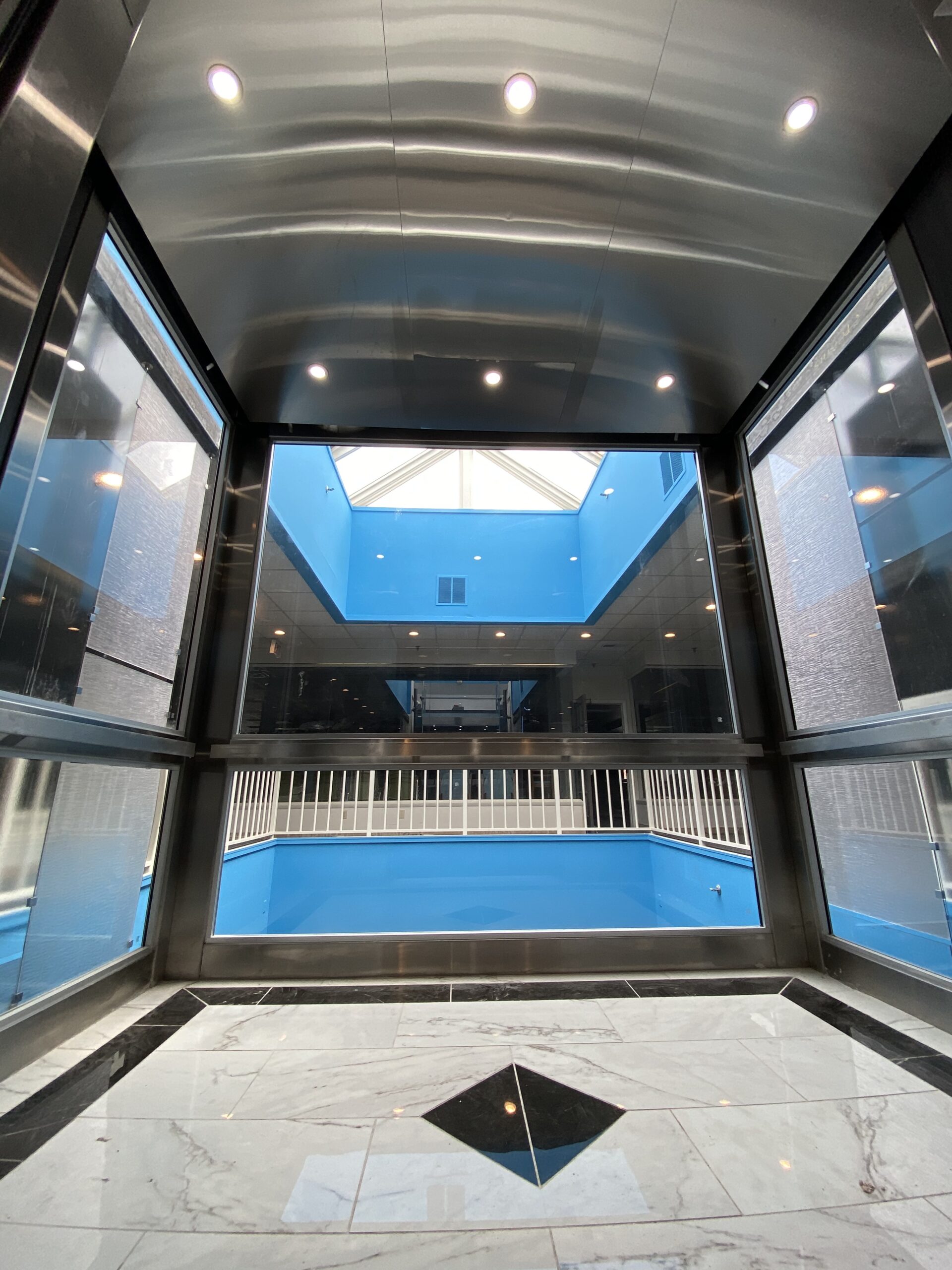 an empty building with a blue pool inside of it