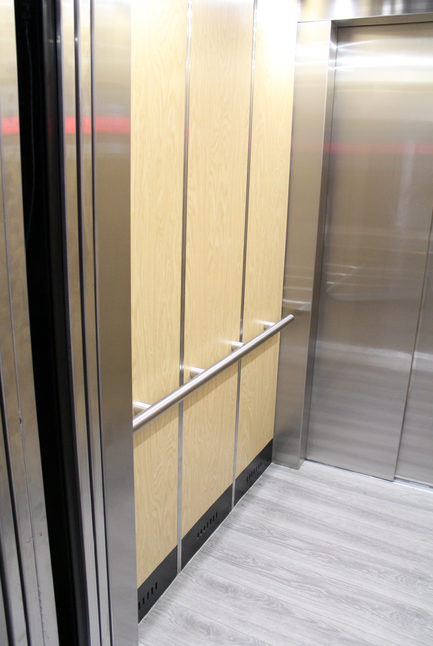 a stainless steel door and a wooden floor