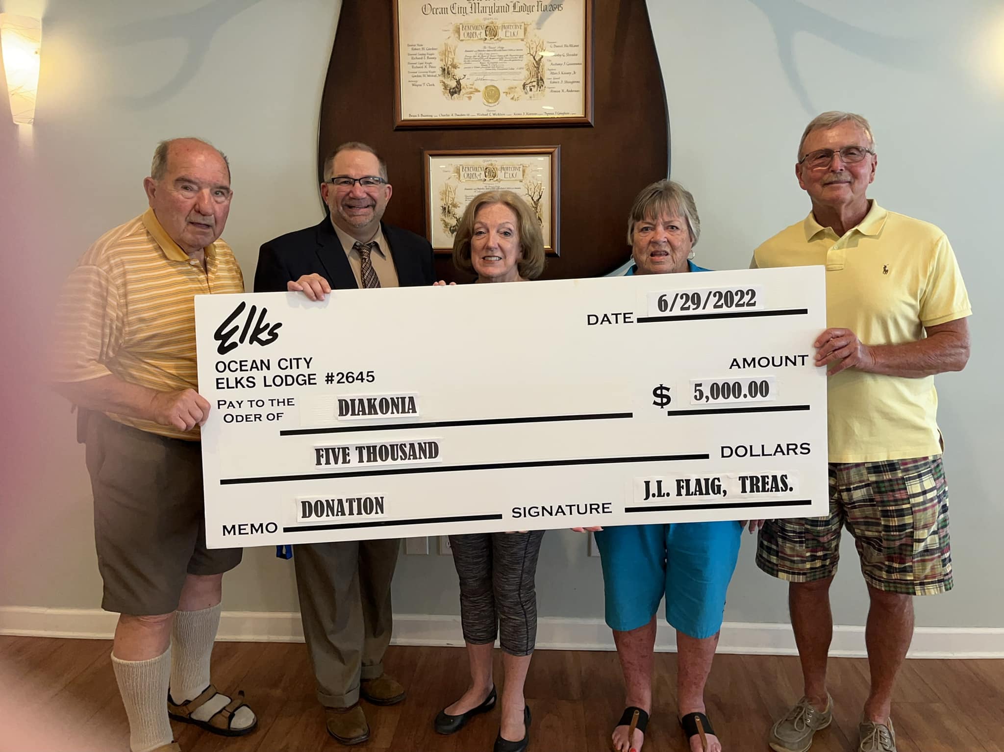 Board members holding check